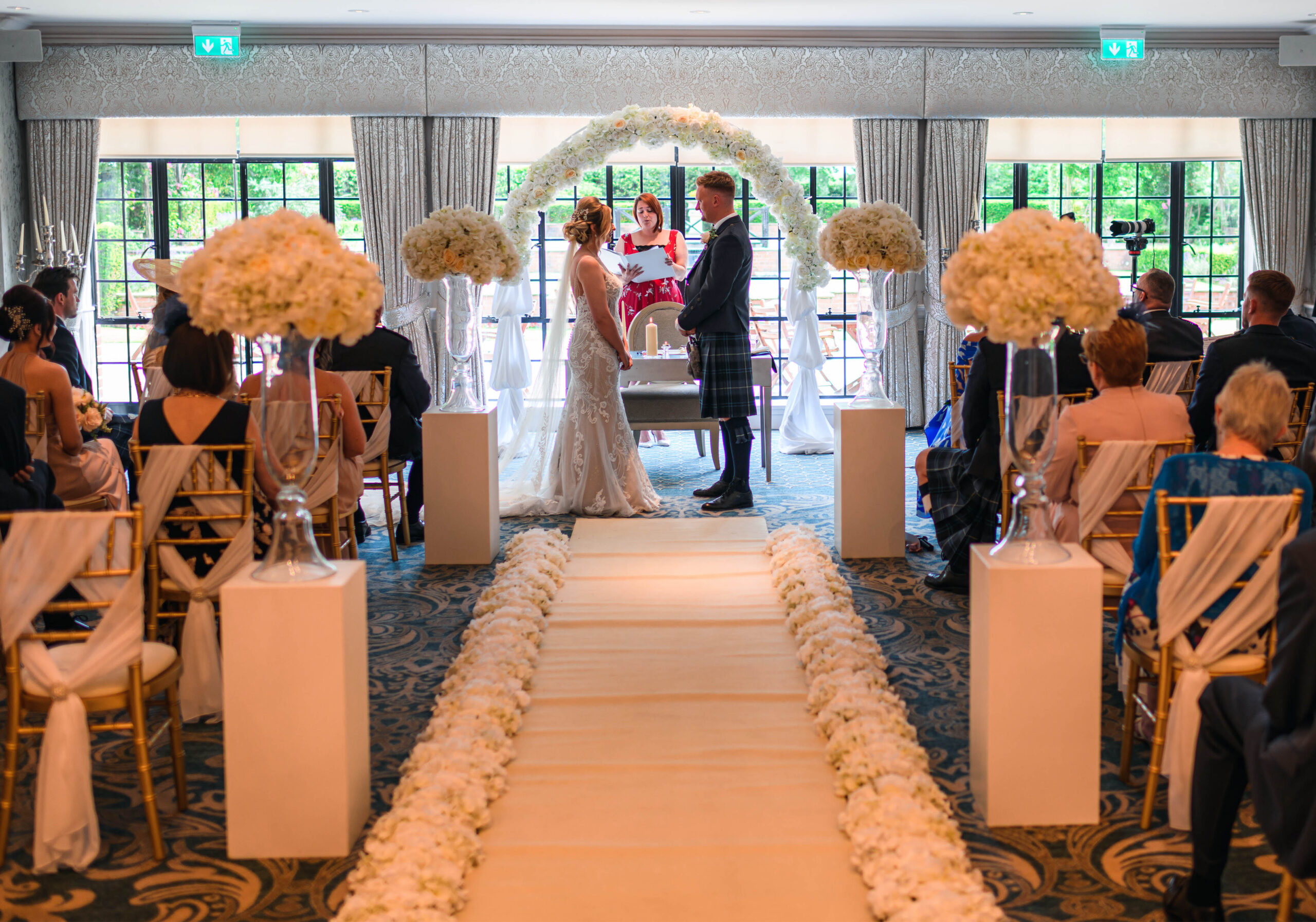 Bride and groom exchanging vows in the Cathedral Ballroom at Ayrshire wedding venue