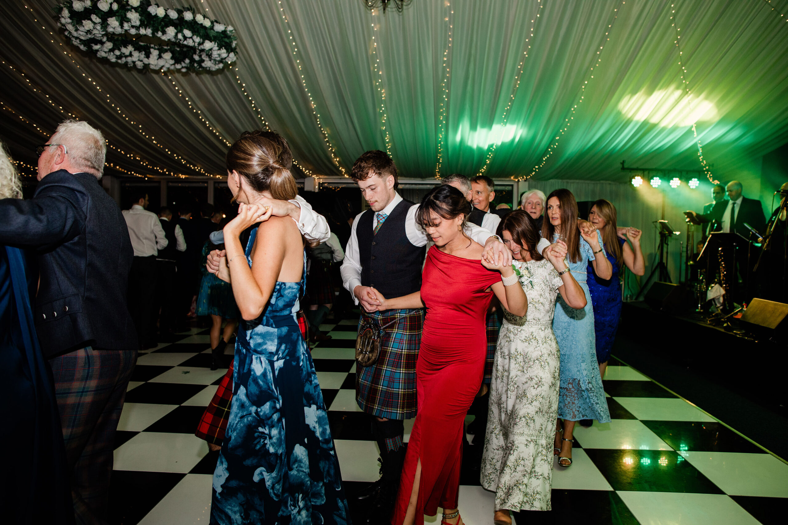 Guests enjoying the evening party in the marquee at Ayrshire wedding venue Western House Hotel