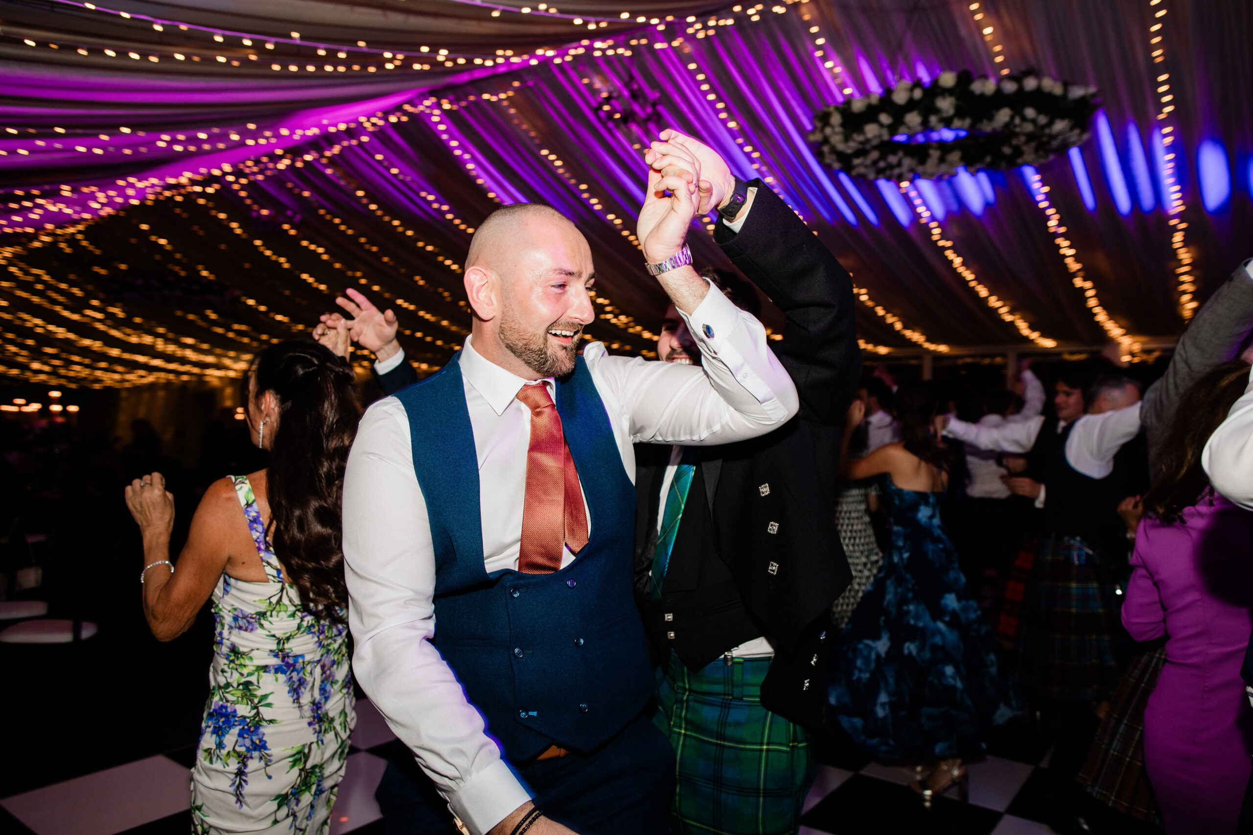 Wedding guests dancing and celebrating in the marquee at Ayrshire wedding venue